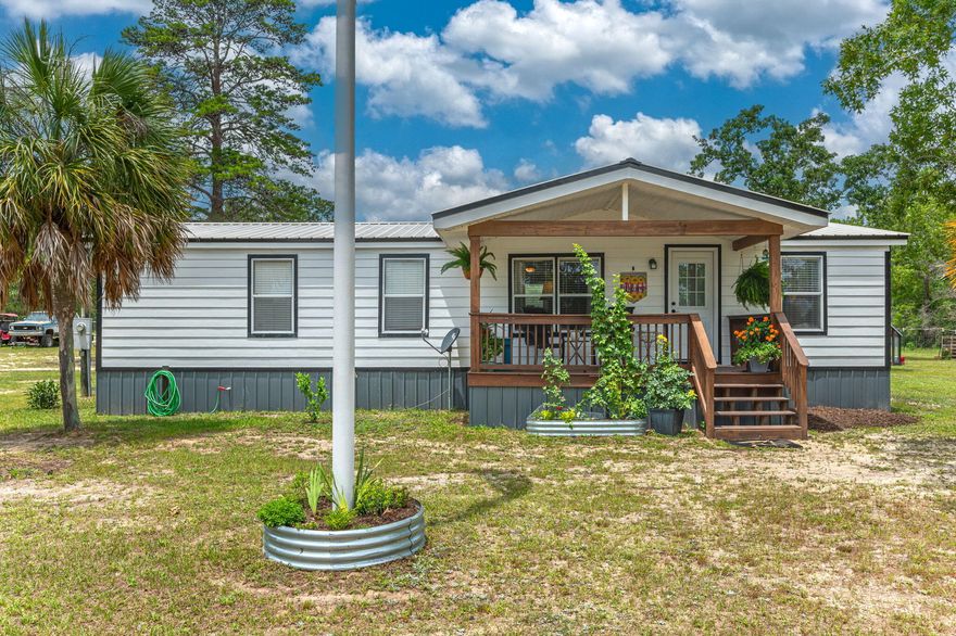 Bring your horses and CHECK OUT this fantastic location w/ convenient access to both I-10 and military bases as well as Crestview, Defuniak Springs and Niceville!! Situated on 4 acres, this 3 bd/2 ba well maintained manufactured home has a cozy covered front porch. Open floor plan w/ nice sized living room, galley kitchen and adjoining dining area. The kitchen boasts lots of cabinets, ample counter space and comes equipped with all kitchen appliances. Master suite has garden tub and separate shower. Cute laundry room has a side access door. Approximately 2 years ago, the exterior of home was repainted, new skirting installed, rebuilt both porches and installed new screens. Fenced pasture out back; 40'x24' pole barn and 25'x26' metal barn. Property is set up for horses!! Within a mile of Hwy 90 and the nearest Dollar General. Buyer to verify all areas of importance. Flag pole and chicken coop DO NOT convey.