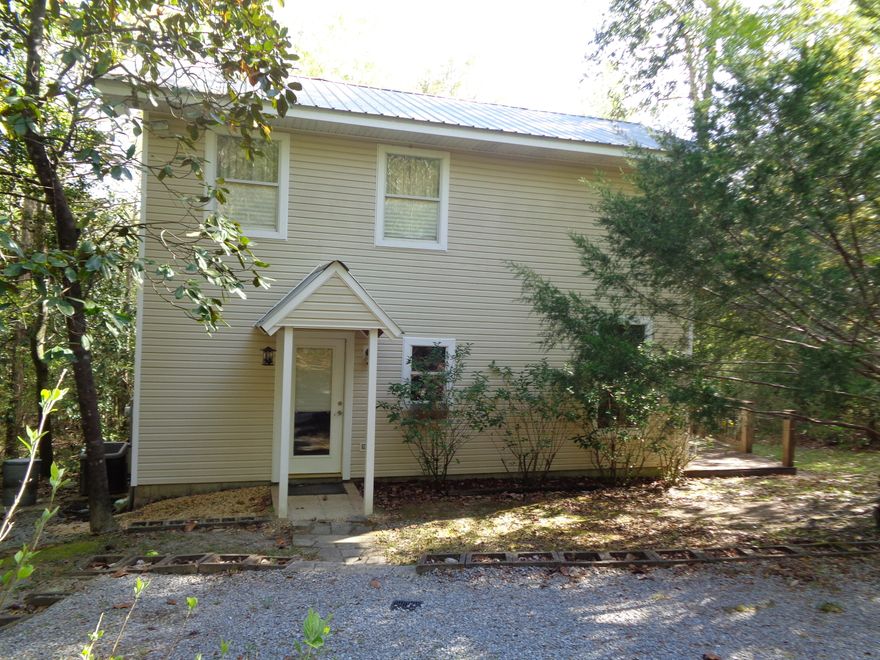 THIS 2 BEDROOM 2 BATH HOME OFFERS AN AMAZING FLOOR PLAN JUST OUTSIDE OF TOWN WITH TONS OF PRIVACY! HOME HAS A OPEN KITCHEN WITH ALL CUSTOM BUILT CABINETS AND CUSTOM FLOORING TO INCLUDE GRANITE COUNTERTOPS AND ALL APPLIANCES. LIVING ROOM OFFERS CATHEDRAL CEILING AND WOOD FLOORING AND TWO FRENCH DOORS THAT ACCESS THE WRAP AROUND PORCH! ADDITIONAL BEDROOM WITH BATH IS LOCATED ON FIRST FLOOR. LARGE UTILITY AND PANTRY AS WELL, THERE IS NO WASTED SPACE IN THIS HOME. THE MASTER SUITE IS LOCATED UPSTAIRS AND INCLUIDES A LARGE WALK IN CLOSET, MASTER BATH WITH DOUBLE VANITY AND GRANITE COUNTERS AND WELL AS MARBLE FLOORING. GREAT FLOOR PLAN AND WOULD MAKE THE PERFECT STARTER HOME, GET AWAY OR RETIRMENT SPOT! LOCATED ON 1 ACRE THIS HOME WITH THE PORCHES AND DECK OFFER ALL THE THINGS NEEDS TO RELAX!