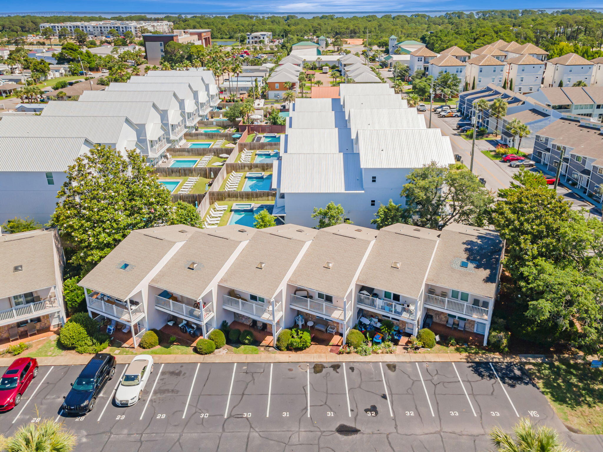 Priced to sell as one of the most affordable homes in the subdivision! Discover your perfect beachside retreat in Woodlawn Shores--just 0.4 miles from the Gulf! This two-story townhouse offers 2 bedrooms, 2.5 baths, and a private balcony with pool views. Inside, enjoy an open-concept layout with smart TVs in every room, arcade games, a full kitchen, and a spacious living area with a sleeper sofa. Community perks include two pools (one heated and just steps away), grilling areas, and a peaceful neighborhood setting. Family-friendly features, full-size washer/dryer, and backyard patio add comfort. Offered fully furnished or unfurnished. Pet-friendly for homeowners! Schedule your showing today and start living the beach lifestyle!