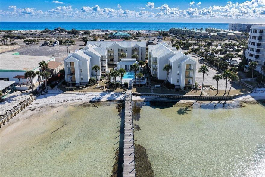 Discover the perfect blend of coastal living and investment potential in this 2-bedroom, 2-bath condo on Okaloosa Island. This second-floor unit offers views of the Choctawhatchee Bay and the community pool from the private balcony. The open floor plan features LVP flooring in the main living areas and tile in the bathrooms. The kitchen includes stainless steel appliances, and the washer and dryer convey. Sold turn-key, this condo has SHORT-TERM RENTAL potential. Community amenities include a bay-front in-ground pool. Low maintenance ownership with HOA fees covering water, sewer, internet, and landscaping. A new HVAC system adds value and peace of mind. Located on Okaloosa Island across from John Beasley Beach Park and adjacent to Gulf Islands National Seashore.