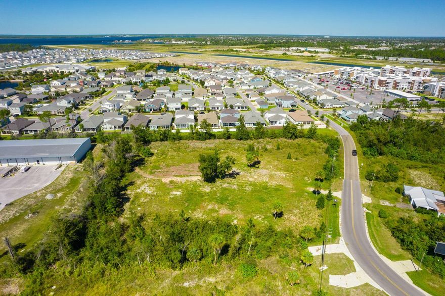 Don't miss this opportunity. Discover an exceptional investment opportunity with this 2.12-acre commercial lot, ideally situated adjacent to the 700-acre Sweetbay master-planned community. Boasting easy access to the newly improved Highway 390, this flat parcel is free from wetlands and easements, ensuring straightforward development.  This lot offers versatile possibilities, including the potential for office spaces or other commercial uses. Can fit a 10,000 sq ft commercial building or a multi story storage complex. Positioned close to the emerging Sweetbay town center, a brand new Publix supermarket, and a future marina, this property benefits from the area's rapid growth and increasing demand. A gas station conveniently located across the street further enhances its appeal.