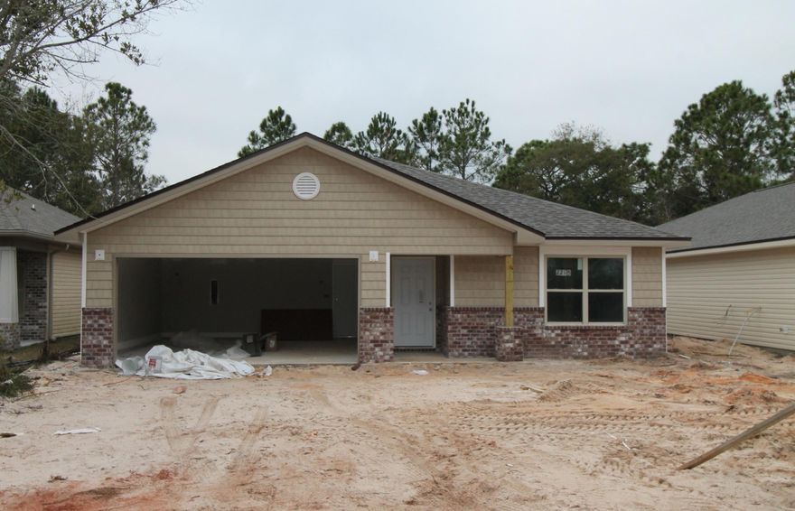 New, custom, 3/2 ''Craftsman Style'', floor plan, with super curb appeal. Great location!!! Seller paying most closing costs, with use of approved lender! Tom Street is on the North side of Hwy 98, just 1 minute past the Santa Rosa County line. 10 Ft. ceilings, 5 1/4'' baseboard, crown moulding, and wood - look plank flooring, are throughout main living areas. Tile is in wet areas. Kitchen opens to the living room, and has custom maple cabinetry, a breakfast bar, granite countertops, a pantry, and stainless appliances, including commercial grade refrigerator/ freezer, with ice maker. Master suite has a large walk in closet, double vanity, and whirlpool garden tub, with separate shower. Huge walk - in laundry is located at the rear of the garage.