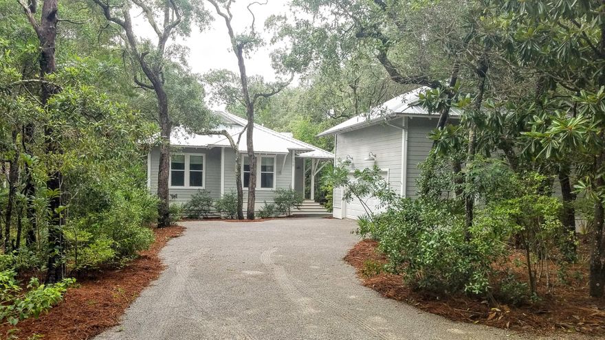 Enjoy the beach lifestyle in this custom Florida cottage with guest house above the 2-car garage, nestled in the trees in coveted Old Seagrove. The world's most beautiful beach and Seaside, with dining, shopping and entertainment, are only a short stroll away from this tranquil setting. The 3/2 home has a one-level, open floor plan with 10-ft. ceilings, lots of windows, 5''-plank white oak floors, gas fireplace and a relaxing coastal palette. The large kitchen has SS appliances, Kraftmaid solid wood cabinets, granite counters and a pantry. A luxurious master suite has a spa bath and large walk-in closet. Spacious screened outdoor living porch, and lush native landscape.
