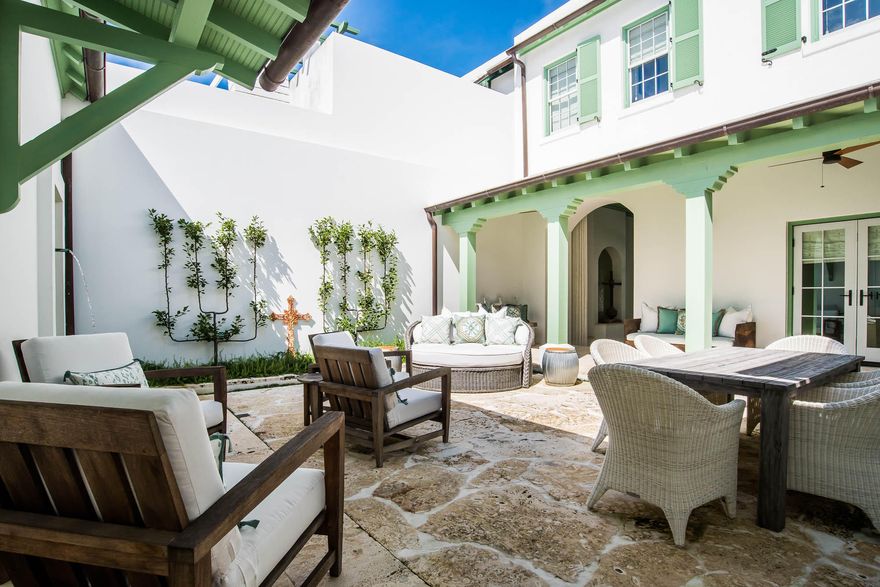 This inviting design by Steve Mouzon captivates you immediately upon entering the Zaguan entry to the courtyard. Upon passing through the nautical rope curtain to the courtyard, you feel as if you were lifted to a new dimension.This 3 bedroom, 3.5 bath, 2,584 square foot courtyard home provides indoor & outdoor living experiences like none other. The breath taking first floor master bedroom provides privacy from the common areas of the home allowing for complete relaxation.The home features an open kitchen looking over the courtyard. Natural light transcends the home showcasing the beautiful reclaimed Red Gum cabinets and wood inlays throughout the home. The kitchen is equipped with Thermador stainless steel appliances, limestone countertops and custom red gum cabinets. The