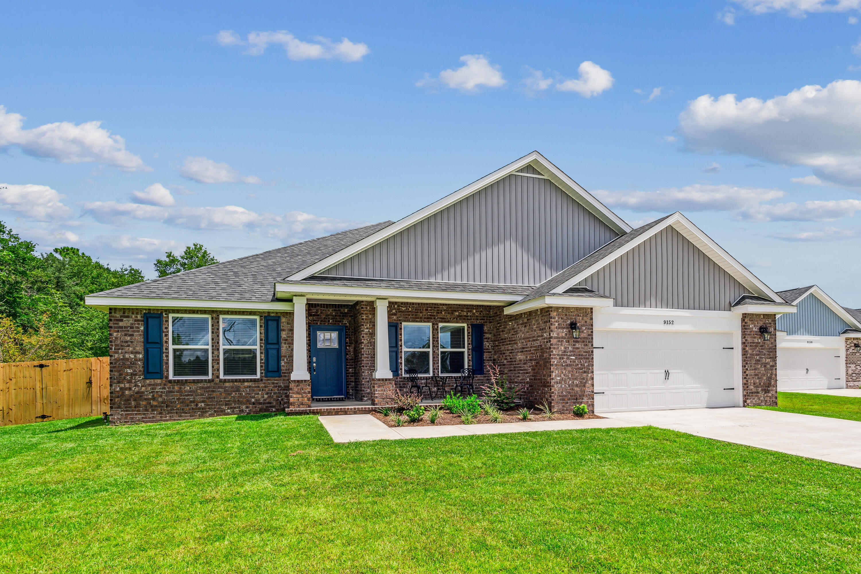 NEW CONSTRUCTION with No HOA! Nestled on a spacious 1-acre lot, this stunning brick home is perfect for those seeking style, comfort, and privacy. The Turquoise floor plan offers 5 bedrooms and 3 bathrooms, including a guest suite with its own full bath, and a flowing open layout ideal for gatherings and entertaining. Step into the welcoming great room that seamlessly connects to a chef's kitchen, complete with stainless steel appliances, granite/quartz countertops, and plenty of cabinet space. The home comes with premium upgrades like crown molding in common areas and 2'' faux wood blinds throughout. Escape to the grand master suite, featuring trey ceilings, dual walk-in closets, and a luxurious en-suite bathroom with a garden tub and a separate tiled shower with dual showerheads.  Enjoy  your fully cleared and sodded 1 acre lot in peace providing ample space for outdoor activities and relaxation. Situated in a highly desirable new subdivision south of I-10, just off Hwy 87, this home offers easy access to both Navarre and Milton. Additionally, you'll be just 20 minutes away from the pristine white sands of Navarre Beach, making coastal living a breeze. Projected completion is March 2025. Photos are of a similar home; colors and selections may vary. Don't miss out on the opportunity to own this beautiful new home!