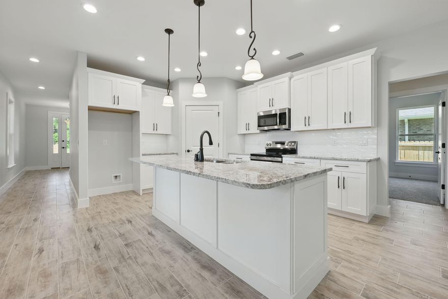 Seller offering up to $12,000 toward buyer closing costs, lender prepaids, and/or interest rate discount points and buyers choice of SS or French Door Refrigerator with acceptable offer. Take advantage of this generous incentive and step into a beautifully crafted all-brick new construction home in the heart of Niceville. This thoughtfully designed residence features 4 bedrooms, 2.5 bathrooms, and an open-concept layout that provides both comfort and functionality.Inside, the kitchen serves as the centerpiece of the home with granite countertops, a large center island with stainless steel sink, soft-close white shaker cabinets, stainless steel appliances, and a stylish hexagon tile backsplash. The main living areas are finished with wood-look tile flooring and recessed lighting, creating a bright, inviting space that flows seamlessly from kitchen to dining to living room.

The spacious primary suite includes a walk-in closet, plush carpeting, and a beautifully finished bathroom with granite double vanity and a sleek glass walk-in shower. Three additional bedrooms provide flexibility for guests, family, or a home office. A full guest bath and an additional half bath offer extra convenience for busy households.

Step outside to a fully fenced backyard with a large covered patioideal for outdoor dining or relaxing in privacy. The oversized two-car garage features a clean, finished interior with attic access, and the interior laundry room is outfitted with upper cabinetry for added storage. A charming covered front porch adds to the curb appeal. Located minutes from Eglin AFB, top-rated schools, and the Emerald Coast's beautiful beaches, this home delivers the ideal blend of quality, comfort, and convenience.