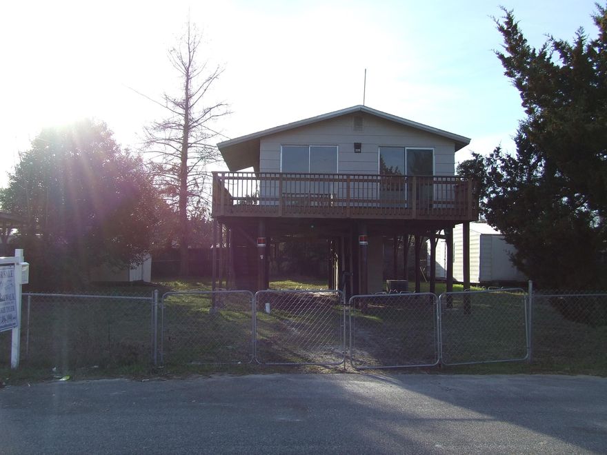 PRICE REDUCED! Charming home built on stilts just 2.5 miles west of Hurlburt Field. Home was completely updated in 2005. Home features a nice sized living room, 2 bedrooms, cute kitchen and bathroom with a big linen closet and pedestal sink. 2 large sheds. Laundry room is located in the front half of the larger shed. 2 brand new houses right across the street and more being built on the next street over. Home being sold as is.