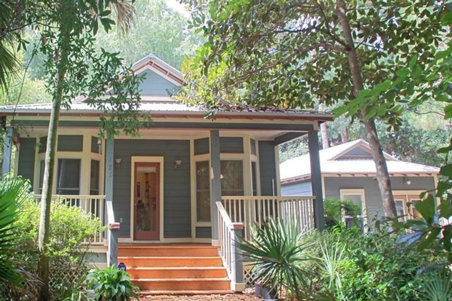 This lovely home and carriage house/studio are located in the popular Daugettes in Point Washington. It is just steps away from the public boat launch to the Choctawhatchee Bay, close to the beaches and Scenic 30A but tucked away from all the traffic. The neighborhood offers many quaint artistic cottages with lots of privacy. The main house has a nice open floor plan with lots of windows and vaulted ceilings. The living and dining areas have 3 large bay windows that allow you to enjoy the views of a wonderful yard full of mature Magnolias and Oak trees, Flowering Crepe Myrtle, Camellia and Azaleas. This home features beautiful hardwood floors in the living room, dining area and bedrooms, with tile in the kitchen, laundry room, and bathrooms. The main house has a huge inviting covered