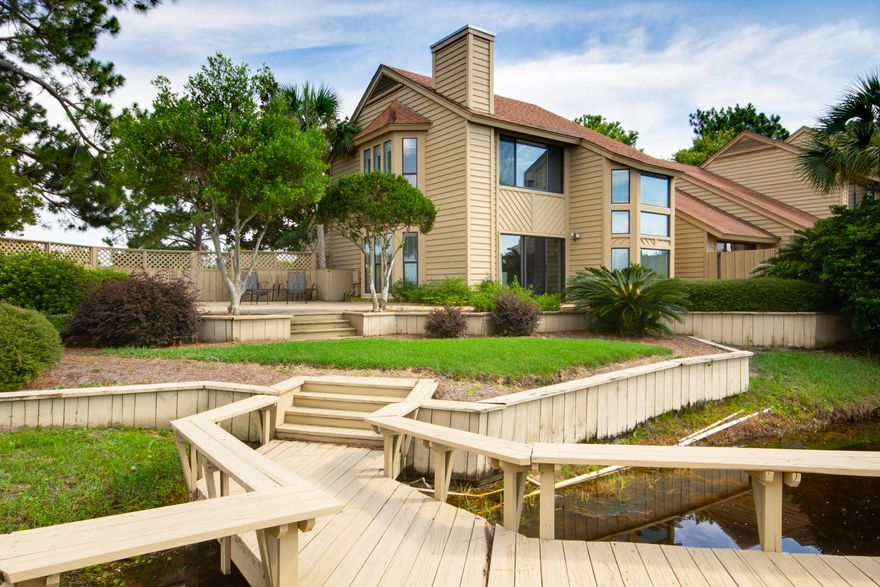 One of a kind, end unit Fairways townhome located on a double sized lot. Golf course, Bay & lake stunning views from the many windows throughout the home. Some of the best features this home offers is the huge open deck, fenced in back yard, a private dock over the lake and private parking. This is an entertainers dream location! The interior is updated with all tile downstairs, granite counters & stunning bathrooms with high end upgrades/finishes. There's a charming hidden nook under the stairs for extra storage, desk or play toys for the kids. There is a bedroom & full bath on the 1st floor with the master & 2nd bed on the 2nd floor. Every room is very spacious & bright! This rare find is offered fully furnished & will not last long!