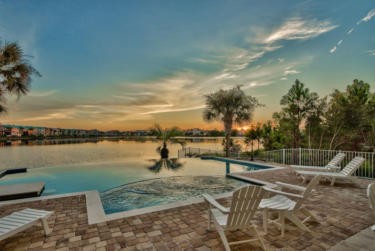 Unparalleled southwest orientation offering beautiful sunset vistas and endless lake views characterize this fully remodeled lakefront retreat optimally positioned in the heart of the gated enclave of Destiny East. Primely situated on a large lakefront homesite and offering updated interiors, this 5 bedroom home has a spacious master on the main level with soaring 12' ceilings and unprecedented resort style pool with a 30' linear edge overlooking the tranquil waters of Four Prong Lake. This rental machine offers over $150K in projected gross annual income and yields world class amenities such as an oversized 2 car garage, private resort pool area and outdoor summer kitchen as well as two oversized living areas masterfully designed to focus beautiful lake views.