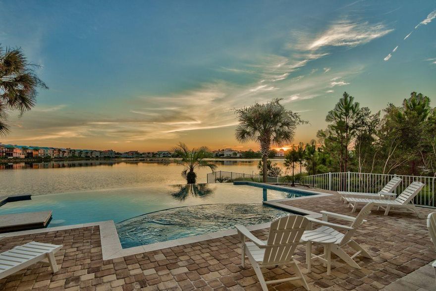 Unparalleled southwest orientation offering beautiful sunset vistas and endless lake views characterize this fully remodeled lakefront retreat optimally positioned in the heart of the gated enclave of Destiny East. Primely situated on a large lakefront homesite and offering  updated interiors, this 5 bedroom home has a spacious master on the main level with soaring 12' ceilings and unprecedented resort style pool with a 30' linear edge overlooking the tranquil waters of Four Prong Lake. This rental machine offers over $150K in projected gross annual income and yields world class amenities such as an oversized 2 car garage, private resort pool area and outdoor summer kitchen as well as two oversized living areas masterfully designed to focus beautiful lake views.