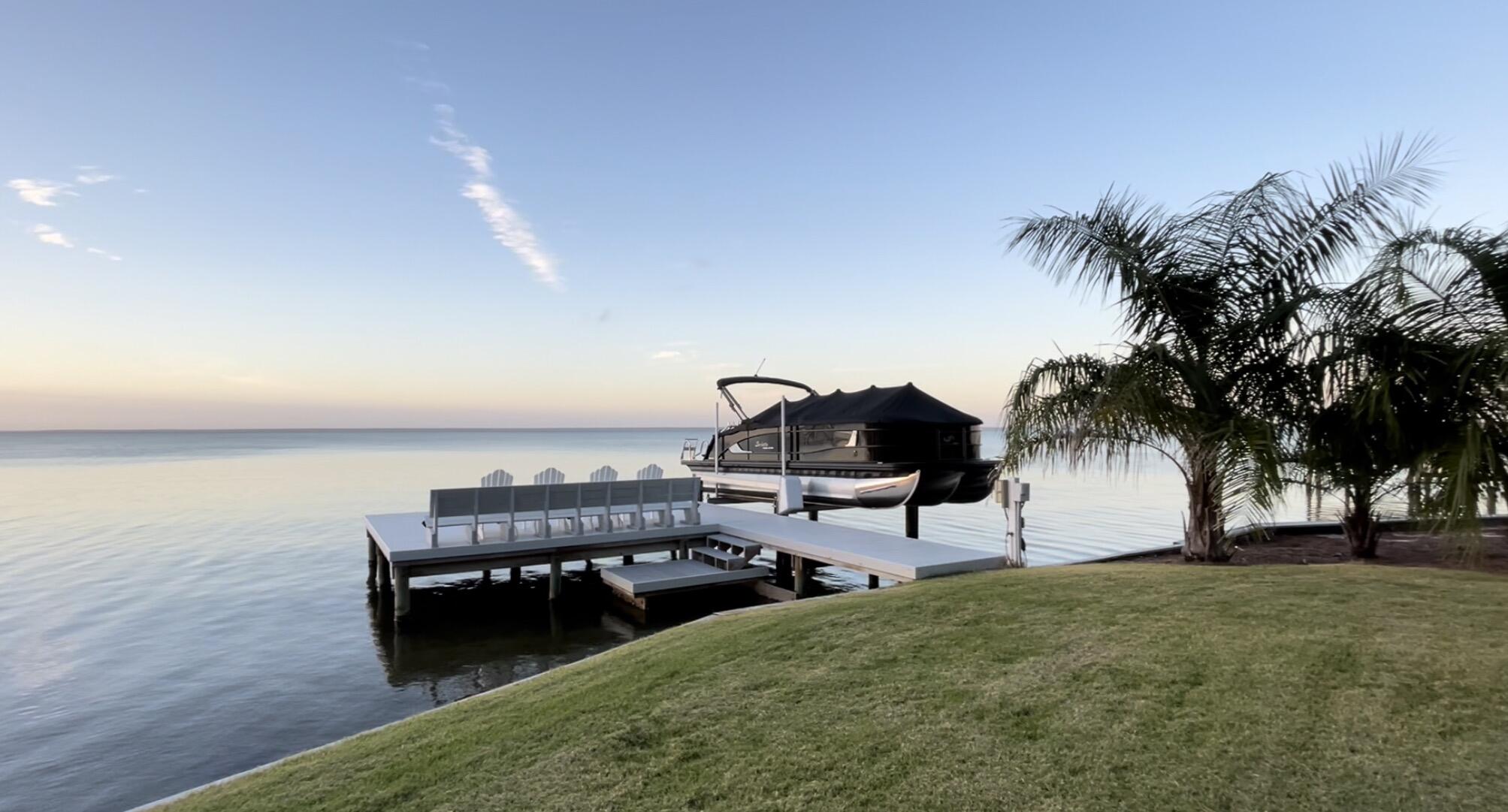 Under contract with a 72 Hour Kick Out Clause In Place. New roof,  HVAC,  water heater,  dock, and boat lift.  The only bayfront home listed in Sandestin outside Burnt Pine.  Bayfront!  Stepping into this home, the peace and serenity granted by the vast views from nearly every room will pull you in.  Recently updated throughout, the open floorplan and high ceilings breathe relaxation. The kitchen offers plenty of counter space for prepping and entertaining, a large pantry and dining space.  The master suite is complete with a large walk-in closet, double-vanity, modern soaking tub, and separate shower. The second bedroom downstairs is a kids' haven with double bunkbeds and trendy accessories. Bedrooms three and four are upstairs, both offering expansive Bay views.