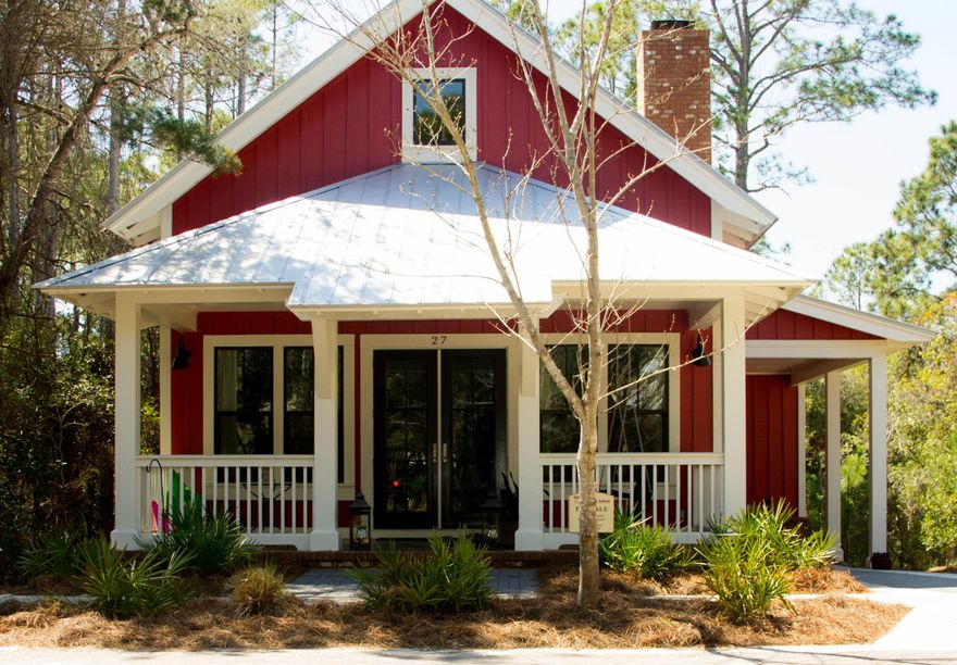 PRIVATE COASTAL ELEGANCE. This best describes this 4 bedroom 3 1/2 bath florida cottage. A stunning living and dining area showcase soaring vaulted and beamed ceilings, a wood burning fireplace, and extensive woodwork framing this grand space. Spot the stained concrete floors on the main and hardwood on the 2nd. See the cook's kitchen with granite countertops and stainless appliances. Drool over the main level master and second bedroom with en suite baths and marble countertops. Upstairs, find 2 more BRs and a jack n jill bath slathered in marble. The upper loft/den is an ideal kid's hangout . Impact doors and windows grant peace of mind. Outside, the shower, deck and generous screened in porch lead to the PRIVATE back yard. Very close to the beach and in a highly coveted neighborhood!