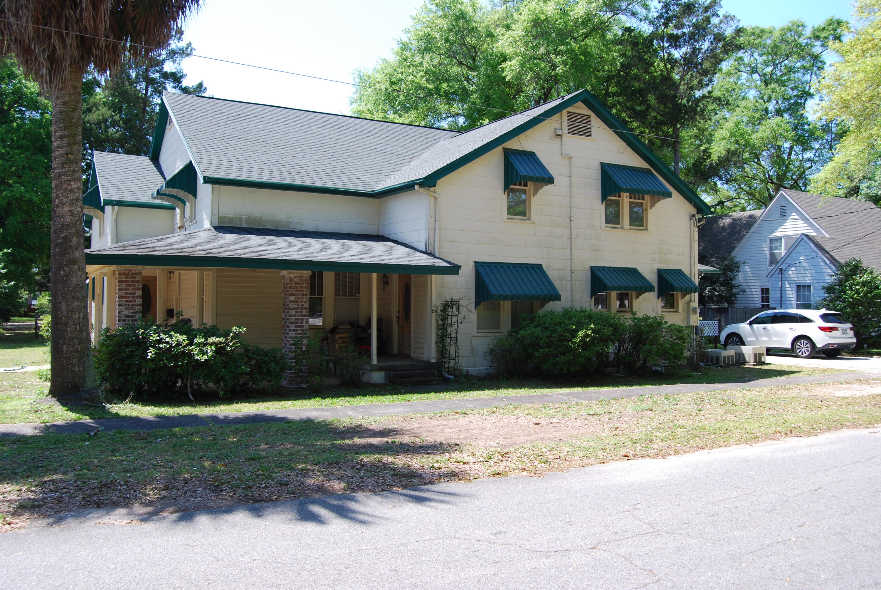 Large Unique two story older home in Crestview. First floor has a living room, Den, two bedrooms, Kitchen, Dining room, two bathrooms,a large utility room, two covered porches and a carport. Second floor has a Kitchen, Living room, Dining room, four bedrooms, two full baths and a utility room. There are two central ac/heat units one for each floor, Roof is about seven years old per seller and the wiring has been updated. This home sits on two lots and is connected to City water and Sewer.