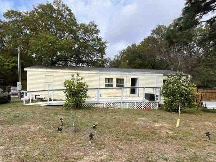 *More photos coming soon.* Charming 3 bed / 2 bath manufactured home on .25-acre lot. The exterior of the home has been updated over the past several years  with paint, front deck with wheelchair ramp, back covered patio, Plus a new roof in May of 2024. There are 2 sheds/workshops with power, and a nice fenced-in back yard. The interior needs some TLC and will not qualify for financing, due to missing flooring in some areas and lack of a functioning central HVAC system. Lots of potential for an investor to fix and flip! Or  a first-time home buyer looking to build some sweat equity could score big on this one!