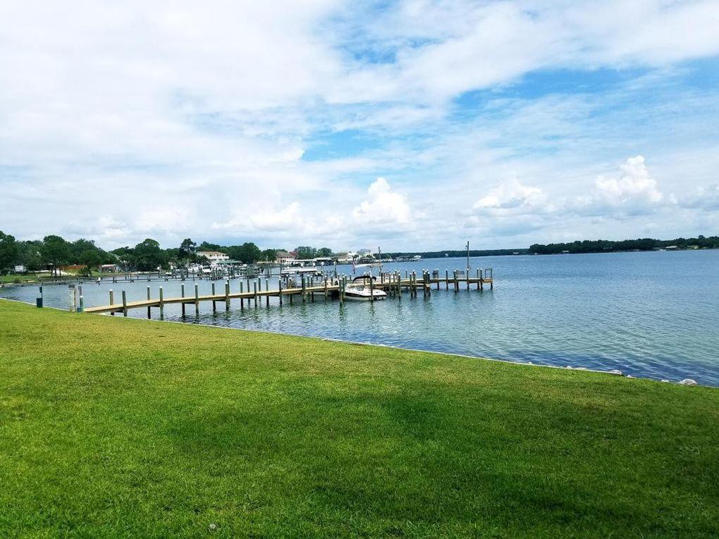 This unit is on the second floor with 3 bedrooms and 1 bath with gorgeous views of the bay! . Amenities include laundry facility, pool, grill stations, and a dock. This is a very well kept condo community. New Carpet and Paint.