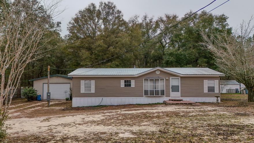 Seller offering $5,000 flex money to buyer! Welcome to 543 Cat Island Rd--a 3BR/2BA manufactured home offering 1,404 SqFt in a great location to Defuniak Springs, wooded setting near Lake Juniper. Enjoy easy country living with a metal roof, a metal shop, and a spacious rear deck--perfect for grilling, relaxing, or entertaining.Inside, you'll find a comfortable, open living area with wood-look flooring and a fireplace, plus a bright dining space that flows into the kitchen. The kitchen features ample cabinetry, generous counter space, and a functional layout for everyday living. The split-bedroom setup provides privacy, and both bathrooms offer practical finishes including a tub/shower combo.Need space for projects, storage, or hobbies? The property includes a large metal shop/garage with a roll-up door, work area, and cabinet storage ideal for tools, toys, or weekend tinkering. If you're looking for room to spread out and enjoy the outdoors while staying convenient to town and the lake area, this one is a must-see!

Buyer to verify all information deemed important.