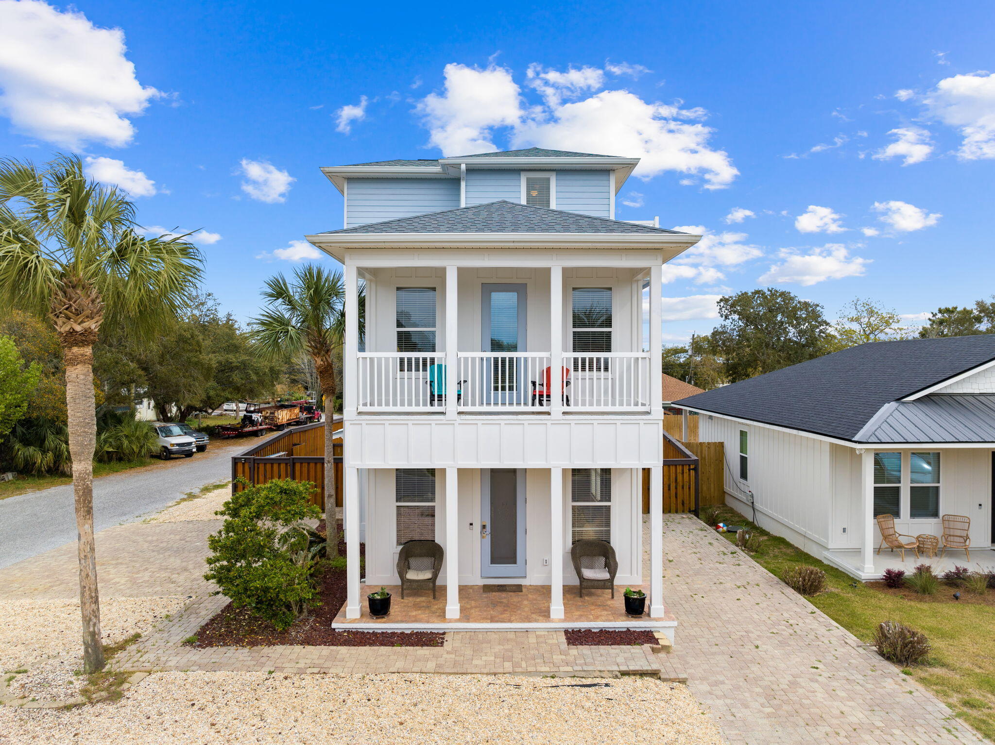 This stunning 3 story home, just two blocks from the beach access, offers 3 beds, 3.5 baths, and a private heated pool. Recently renovated exterior enhances its curb appeal. The first floor boasts high ceilings, a spacious living dining combo, a well equipped kitchen with granite countertops, stainless steel appliances, and a breakfast bar. Additionally, a half bath, separate laundry room, and a master bedroom with an ensuite bath and walk in closet open to a backyard with a new fence and a heated pool. The second floor hosts another master bedroom, a guest bedroom, and bath, along with a balcony. The top floor features a bonus room, small game area, and balcony with gulf views. Parking includes two spots and additional driveway space. Perfectly situated near Pier Park, this home... offers easy access to amenities year round, making it ideal for primary residence, vacation home, or investment property. Don't miss the chance to own this amazing property!