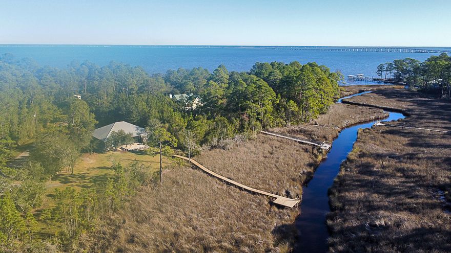This custom-built waterfront home includes two lots totaling 1.84 acres. Enjoy kayaking, Yolo boarding, or keep a pontoon boat at the end of the newly updated dock. Inside boasts an open floor plan with shiplap walls, new white oak flooring, reclaimed cypress accents throughout the house, and a reclaimed brick fireplace.Additional features include; a fully remodeled laundry room with all new appliances, sliding barn door opening to an oversized pantry with attic access, 10' x 17' master closet, custom cabinetry throughout, farmhouse sinks, gas-top stove, Rannai tankless gas water heater, outdoor shower, spray foam insulation in attic. All doors are solid core, exterior doors and windows are all 145 MPH Impact Rated.Owner is a Florida Licensed Real Estate Broker.