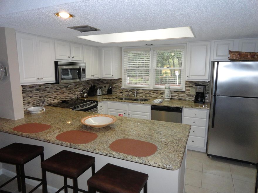 Pleasant to the eyes & relaxing to the soul, the unique touches found in the shabby-chic yet beachy interior will have you completely enamored. New kitchen featuring granite counters, stainless steel appliances & a custom tile backsplash add a sophisticated air to this bungalow. The two bedrooms with their hardwood floors and gorgeous linens look like they were torn from the pages of a magazine.Added niceties include a screened in wraparound porch with comfortable chaise lounges, two pools & the beach, & pro tennis courts & a lighted basketball court right on site. Plus many enjoyable hours can be spent meandering through Hidden Dunes walking trails & then combing the beach for shells. Plenty of amazing shopping & dining is about two minutes away.