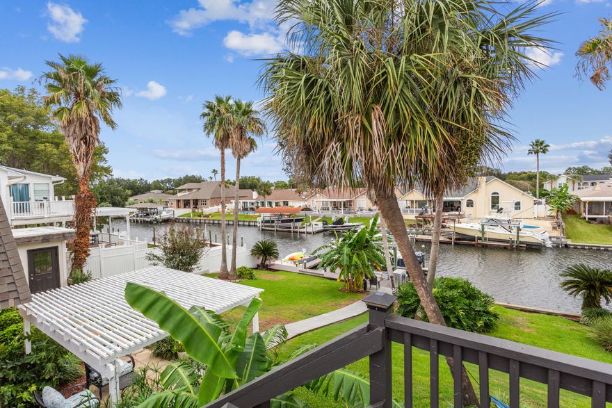 ** You are going to fall in LOVE with this absolutely stunning Canal Front home located in popular Santa Rosa Shores ** If you are an outdoorsy person, this may be your match! Nestled on a Deep Water Canal, you will find a 20,000 lb boat lift, floating dock, North Star PVC seawall, Trex decking, and more!! Tons of outdoor living space to enjoy the Florida lifestyle through all seasons ** Hosting a party? Throw it on your massive Upper Deck (783 sq ft) off the Kitchen/Dining area and overlooking the canal. The space is amazing and the views are outstanding! Want to watch the game in a shaded outdoor space? We have that too! Off the backyard  and the primary bedroom there is a cozy shaded deck area complete with a shower room great after a long day of boating ** Inside you will find all the Inside you will find all the bedrooms on the 1st floor, with the primary bedroom overlooking the meticulously maintained yard and water ** En suite bath has been remodeled to all travertine stone, seamless glass shower doors, and radiant heated floors ** Upstairs is all the living space featuring gorgeous views, kitchen, dining area, great room and 1/2 bath ** A courtyard separates the main house from a 638 sq ft detached bonus room ** There are multiple options for this space, the current owner uses it as a game room ** Windows have a life time transferable warranty  ** 2 separate storage buildings  ** Plus this is a golf cart friendly community right around the corner from Tiger Point Golf Course and Swenson Park that has tennis, pickle ball, basketball, and playground!! Come take a look!
