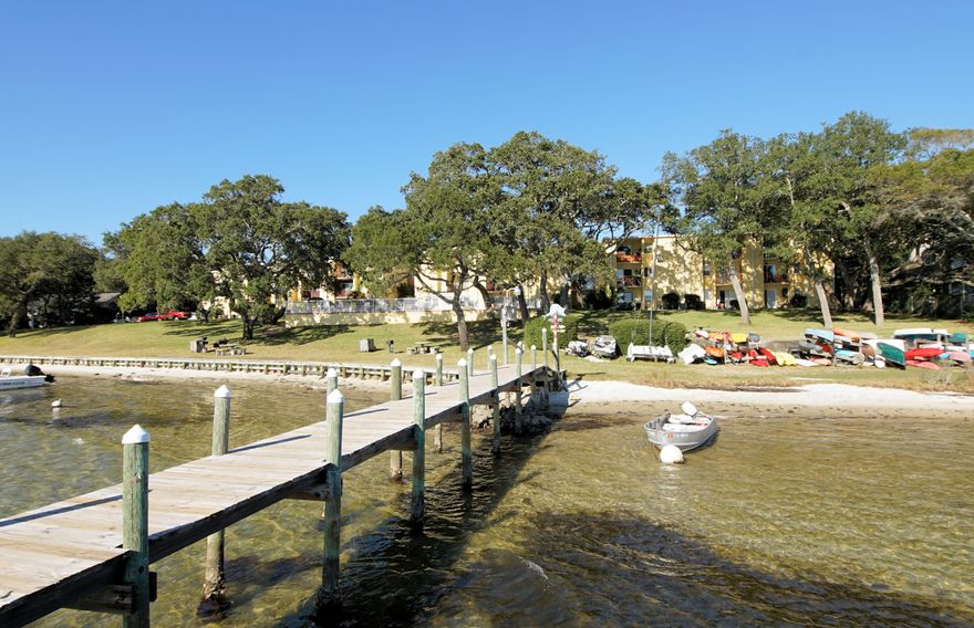 Motivated Seller!! This 2 bedroom and  1 bath condo has 965 sq ft and is on the first floor on the front side of the Cedars Condo for easy access in and out of the condo project! Investor dream! Already rented for you at top dollar! Short term rental allowed!The Cedars community offers boat docks, pool, elevators, rec room, kayak storage, and laundry facilities. Relax in the waterfront pool or under the beautiful Oak canopies that shade the courtyard. Cedars is close to the white sandy beaches of the Gulf of Mexico! This waterfront condo has beautiful western sunsets! The condo unit A104 is also very conveniently located in Cedars Condo! You only share one wall with this end unit! Buyer to verify all dimensions and information. 