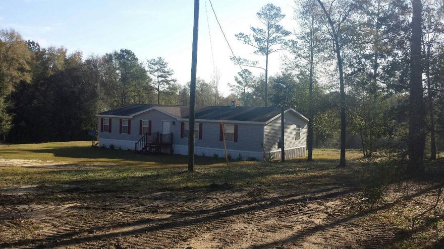 BETTER THAN NEW! This three bedroom, 2 bath mobile home is on 16 acres of land southeast of DeFuniak Springs. Features wood burning fireplace, large kitchen with stainless appliances, front porch and large back deck, fenced pasture area, creek and workshop building. Home is located a short drive to boat landing at the river and is also a great area for hunting! Qualifies for FHA financing too! Make an appointment today to see this rare opportunity to buy with all the work done!