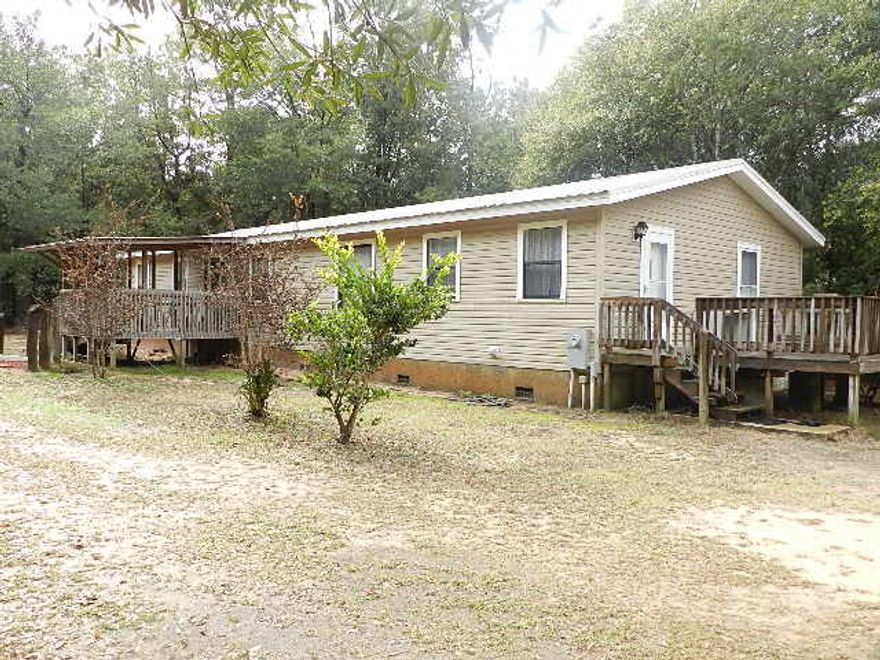 A unique opportunity to purchase a 3 acre parcel,that's secluded, but bordered on this corner lot by two paved streets maintained by the county. This 1972 traditional style 3 bedroom, 2 bath home with elevation and has crawl space for easy maintenance. A Split floor plan, 3 large bedrooms, finished wood cabinets, upgraded appliances, large laundry, walk-in closets, many extras in this custom built home. Home is designed with 2 x 12 floor joist, 2 x 6 construction and hand built rafters, standing seam metal roof, vinyl siding, storm shutters, front porch, side deck and back porch. This property offers a 30x30 workshop, 3000 psi concrete flooring, storage, workbenches, high ceiling, a hobby shop with heat and air adjacent to workshop. Exceeding building code requirements with threaded rod