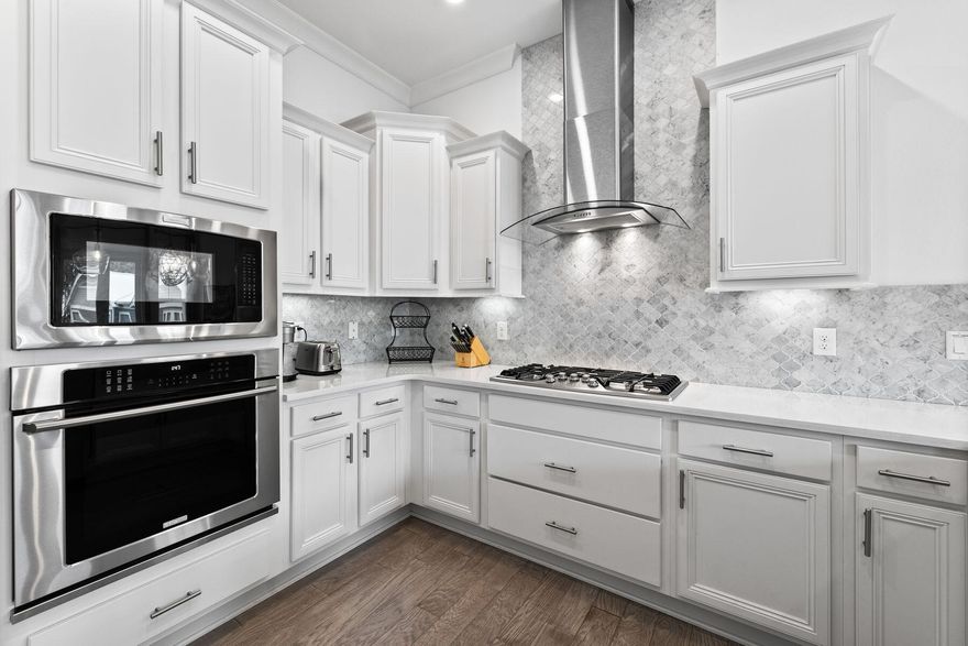 Welcome to this adorable Prominence Townhome! This 2-bedroom, 2-bathroom residence offers a perfect blend of modern comfort and convenience. Step inside to discover a beautifully maintained interior featuring quartz countertops and engineered hardwood flooring throughout. The open-concept layout seamlessly connects the living, dining, and kitchen areas, creating an inviting space for both relaxation and entertaining. Whip up delicious meals in the gourmet kitchen, equipped with Electrolux and Bosch stainless-steel appliances, while enjoying the company of friends and family. Both bedrooms are generously sized, providing ample space for privacy and rest. The primary bedroom includes an en-suite bathroom with double vanities and a walk-in closet for added convenience.