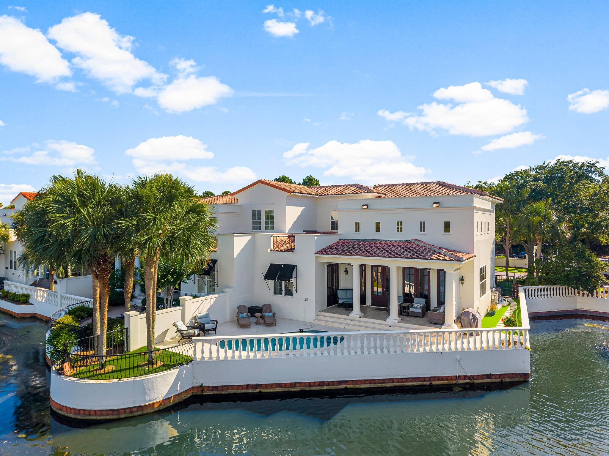 Welcome to this exceptional two-story villa in the exclusive community of Fountains at Sandestin--where serene lakefront living meets refined luxury. This recently renovated Jewel is perfectly positioned to capture sweeping views of the lake & Golf Course, offering a lifestyle of comfort, elegance, & tranquility.Step into a welcoming front entrance with travertine flooring & soaring 18-foot ceilings with clerestory windows create a dramatic & light-filled living space. A wall of glass doors frames stunning vistas of the lake & fairway, seamlessly blending indoor & outdoor living. This villa is ideal as a primary residence or a second home, with no short-term rentals permitted, ensuring a peaceful & private oasis! Just a short stroll away, discover many vibrant boutiques & restaurants.
