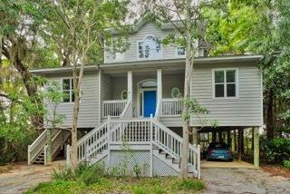 WATERFRONT!!! 100 ft. Experience the best of both worlds living in the seclusion of Point Washington forest close to beaches, yet a world away from crowds and congestion. Elevated on tall pilings, the elegant bay front home rises up like a tree house into the sheltering boughs of massive live oaks, graceful magnolias, and towering pines skirting the sandy beaches of Choctawhatchee Bay. Designed by Wayne Windham, a renowned Charleston architect. Outdoor beauty is brought indoors through a dramatic placement of custom designed windows so every room enjoys a view. Across the back of the home facing the bay, a wall of windows and glass French doors open onto a screened porch and deck to offer expansive bay and forest view. An additional half acre is also available.Perfect for a guest ho