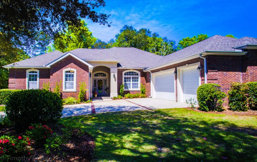 Distinctive custom built home in prestigious Magnolia Plantation. You'll be dazzled by the spacious great room, tray ceiling with double crown molding and gas fireplace. Custom Italian tile floors and a series of elegant French-doors provide a beautiful view of the outdoors. The gourmet kitchen boosts 42' designer cherry cabinets, granite counter tops, under cabinet lighting and island and a built in wine chiller. Designed for the home chef the kitchen is appointed with top-of-the-line stainless appliances with gas cooking. Brazilian cherry wood flooring adds a warm touch to the formal dining room. The homes features grand columns and arches and 18 inch Italian procelin tile floors give this home a luxurious feel! Spacious master suite features a double tray ceiling with crown molding,