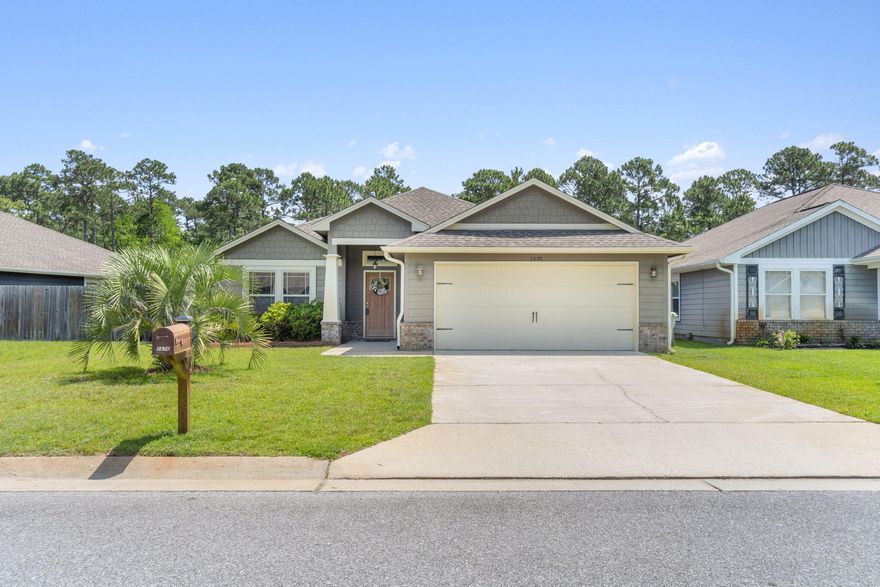 Experience the epitome of comfort & style in this charming 3-bed, 2-bath home. Boasting crown molding & trey ceilings, it exudes elegance. The large kitchen, complete w/breakfast bar, granite countertops & stainless appliances, is perfect for culinary adventures. The walk-in pantry adds convenience. Retreat to the master suite, featuring 2 closets, double vanities, a soothing jacuzzi tub & separate water closet. Gorgeous wood flooring adorns the living area, enhancing the home's chic appeal. Step outside to the covered lanai for serene evenings, surrounded by a privacy-fenced backyard. Unique to this property is one of the largest backyards in the neighborhood, offering a peaceful backdrop of wetlands, ensuring no neighbors behind. A true sanctuary, where beachside living meets comfort!!