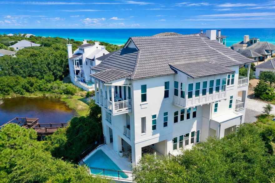 Welcome to an exceptional coastal retreat in the gated, non-rental community of Stallworth Preserve -- 68 Stallworth Blvd. This masterfully designed 3-story home, built in 2021, embodies refined beach living with sweeping views of the white sand beach and emerald green waters of the Gulf. As if Gulf views weren't enough, this gem is located on a coastal dune lake as well. Step inside to discover ~3,908 sq ft of living space highlighted by 5 spacious bedrooms and 7 baths (five full, two half). On the ground level you'll find a welcoming entry, laundry area, a two-car attached garage, and an amazing outdoor living area complete with a summer kitchen and a private pool -- all overlooking the serene coastal dune lake. Upstairs, four bedrooms each come with their own ensuite bath, offering privacy and comfort for residents or guests. The top floor is dedicated to living at its finest: a luminous living room, dining area, and gourmet kitchen all arranged to maximize the stunning Gulf and lake views. Also on this level is an expansive master suite, making this the ultimate retreat space. This home combines beach house charm with modern amenities: double-pane windows, storm-ready doors, ceiling fans, a tankless water heater, and efficient electric systems. Outside, the property sits on an ~8,712 sq ft lot in a private, secluded enclave with direct beach access located just across the driveway. A rare find in this prized 30A neighborhood. Whether you're seeking a luxury retreat, a coastal vacation base, or a high-end investment property, 68 Stallworth Blvd presents a rare opportunity combining privacy, panoramic water views, and turnkey elegance, in a location that offers both serenity and access to the Gulf.