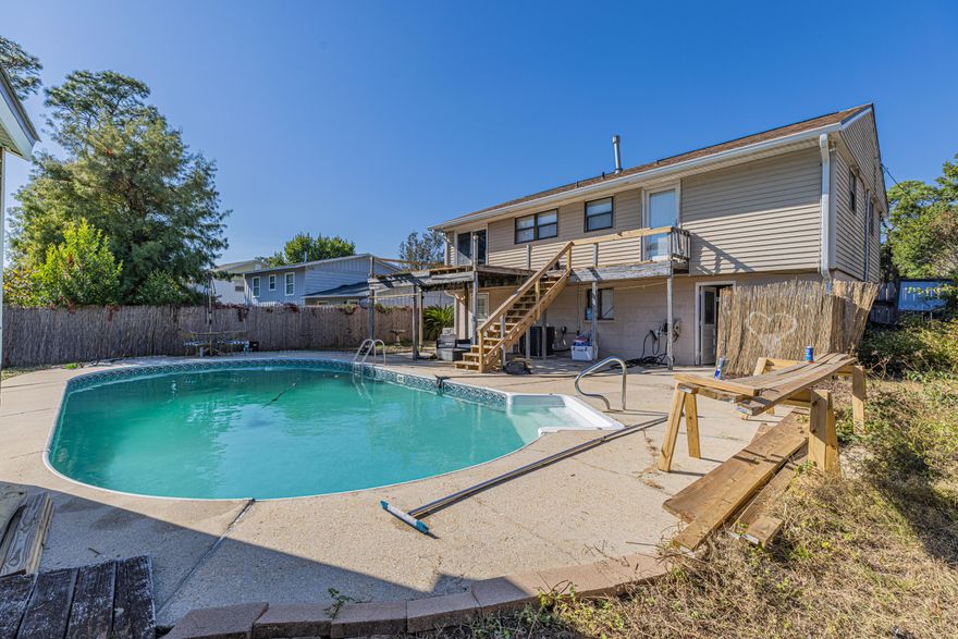 Pool home offering a spacious and comfortable living space with 4 bedrooms and 2 bathrooms looking for its new owner! As you enter this charming home, you will be greeted by a split-level design that adds a unique touch of character. The main level has a great sized living room and formal dining area. Beautiful kitchen with highly desired gas cooking, granite countertops, and offering tons of cabinets and countertop prep space. Three bedrooms upstairs are generously sized, offering plenty of space for relaxation and personalization. Master bedroom is located downstairs and comes complete with its own bathroom, providing privacy and convenience. Fully fenced in back yard with inground pool makes the perfect canvas for your summer days. Whole home gas generator completes this amazing