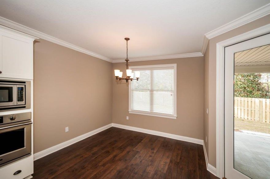 The Live Oak plan has 2,598 square feet, three bedroom, plus a study and 2 baths with steel tubs and tile surround. Brick exterior, low E-vinyl windows, covered large rear porch and a 2 car garage. Interior finishings include, 9' ceilings, granite counter tops, laminate, tile and carpeted floor coverings, crown molding, cased windows and openings. Floor plug in living room. Drop in sink in laundry room with upper and lower cabinets. Fence included!! Natural gas range and Rannai tank water heater. Stainless Frigidaire appliances, WoodHarbor cabinets with 100 year finish warranty. Hammock Bay is a 3,200 acre master planned development which offers a clubhouse, movie theater, pools, workout facility, nature trails and a pet park.