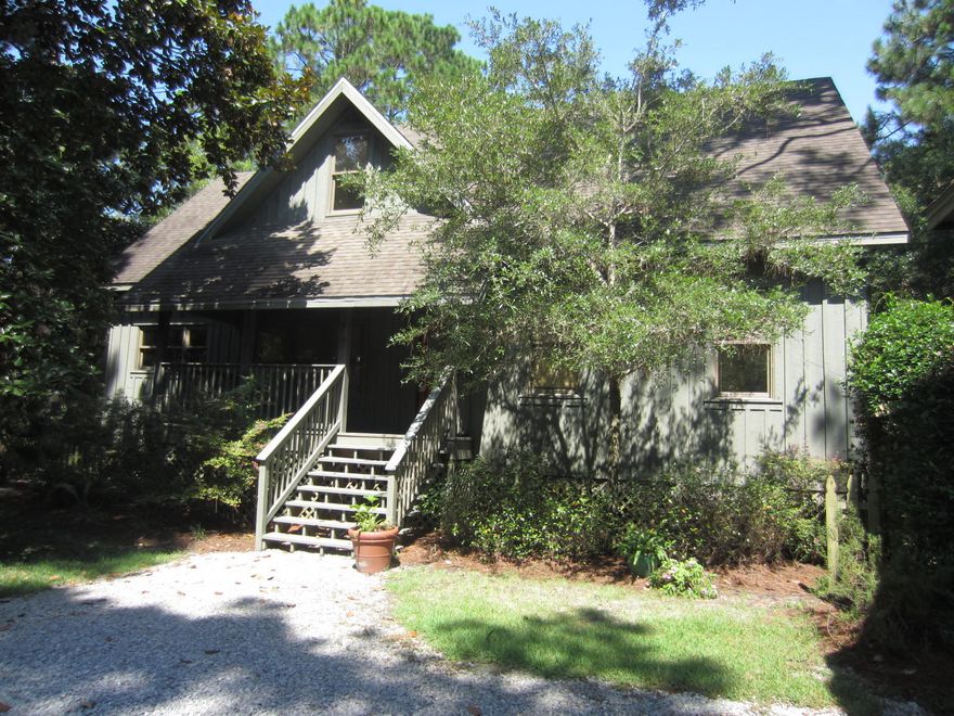 Grayton Trail 3 BR 2BA main cottage with 1BR 1 BA efficiency carriage house including 2.5 car garage on huge .63 acre heavily wooded site in Grayton's most exclusive subdivision. Exterior siding is all-natural cypress board and batten. The main house interior features oak hardwood flooring, 9'ceilings,throughout 1st floor. The open and light living/dining area flows onto huge rear screened porch. The modern 'eat-in' kitchen has granite countertops and custom cabinets. There is a sizable mudroom you conveniently enter off an 8'x10' rear grilling deck adjacent to an outdoor shower area. The entire 2nd floor is the master suite with a bonus room with extra storage that can easily be an office.
