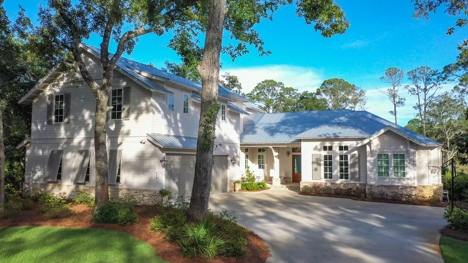 Botany Bayou is a secluded, gated neighborhood filled with live oaks on Hewitt Bayou, close to all the necessities of life. This custom-built home with 100' of water frontage has it all including a covered dock with two boat lifts and a private saltwater pool. The entry way with its circular wall of windows allows your view to extend over the pool, through the lush backyard all the way to the water. The 14' vaulted ceiling with reclaimed hand-hewn beams from an old barn in Wisconsin crown the dining living room. Calcutta Gold marble along with Subzero/Wolf appliances, coffee/cappuccino maker and steam oven make entertaining a breeze. The outdoor living & dining areas with fireplace, outdoor kitchen and lounging area overlook the pool. Master bedroom with striking Snow White marble,