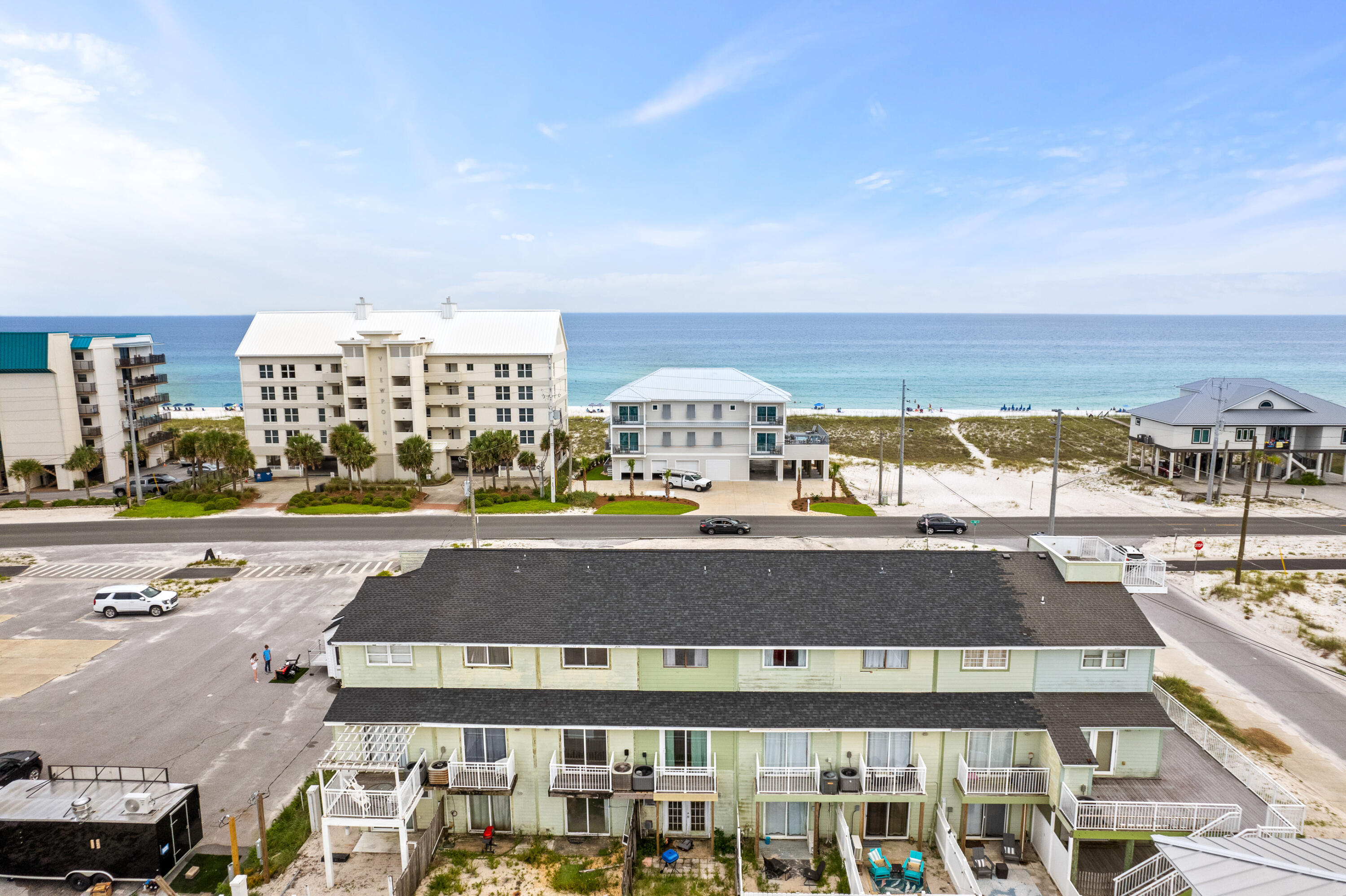 Unique Lockout Unit with Water Views of Navarre Beach with a studio on the first floor and 3 bedroom/2 bath unit upstairs on the 2nd and 3rd floor!! You can rent them as one unit with 4 bedrooms or two separate units! NO HOA!! Over $47,000 in rental income for 2023; over $42,500 already received for 2024!!The ground floor houses a full-size studio with a sliding glass door leading to a fenced-in, uncovered back patio. This studio unit includes a fully functional kitchenette including a small refrigerator, a stove, and a new microwave, along with a full bathroom, making it count as the fourth bedroom in the MLS listing. Separate access ensures privacy and convenience.The main unit spans the second and third floors. On the second floor, you'll find a guest bedroom with a private balcony overlooking the fenced patio and a balcony off the main entry door, perfect for enjoying morning coffee or evening wine with water views of Navarre Beach. The third floor features the master bedroom with a private balcony offering stunning water views of the beach, a third bedroom with double bunk beds, and a full bathroom (one on each floor).
This townhome comes with a covered carport and one deeded parking space, and it is part of a small, exclusive complex with only seven other units. The covered carport includes shelving and hooks for beach supplies and rafts, and there is a shared outdoor shower area for both units. Additionally, a shared laundry room with a new full size washer and dryer is located in the foyer area on the first floor. It is located just 0.3 miles from the beach access, it's a short six-minute walk or one-minute drive.
The property is turnkey and rental-ready, sold fully furnished, with existing reservations on the books that can be transferred upon the sale. The roof was replaced in 2021, ensuring peace of mind for new owners. Situated directly across the street from Navarre Beach, this townhome is close to multiple restaurants, including a new Starbucks and Buffalo Wild Wings, and numerous public beach areas, making it a popular vacation spot for families and friends. Don't miss the opportunity to own this versatile, income-generating property in beautiful Navarre Beach, perfect for investors or those seeking a beachside getaway!