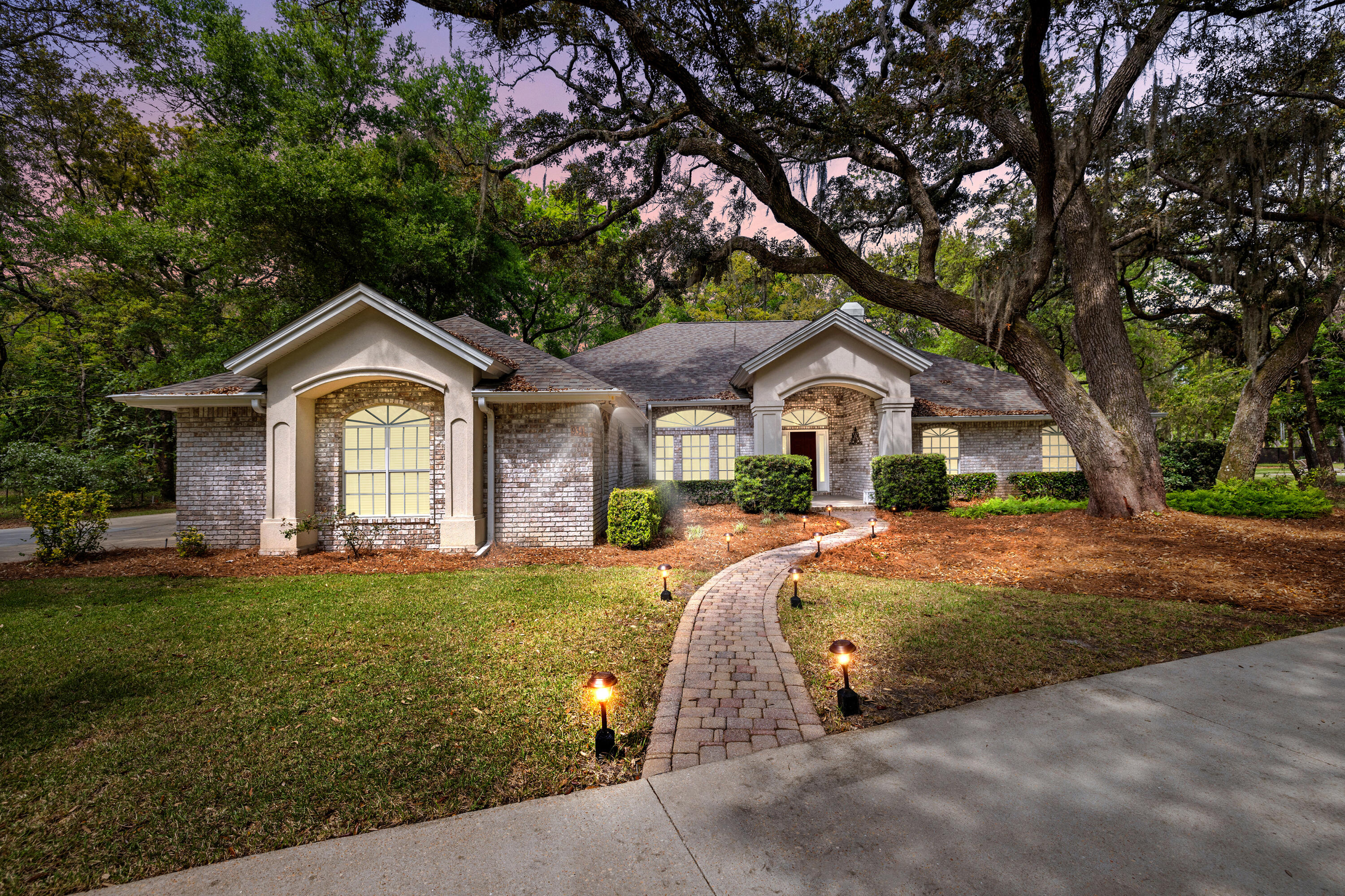 Welcome home to this warm and inviting custom-built residence in Lake Pippin Estates, one of Niceville's best-kept secret neighborhoods. Nestled on a tranquil 1-acre lot, this 4-bedroom, 2-bath home offers a perfect blend of comfort and elegance. From the moment you arrive, you'll notice the charming brick exterior with stucco accents and the convenient circular driveway welcoming you and your guests. The attached 2-car garage with golf cart garage and extended side driveway provide ample parking and even space for a boat or RV.Step inside and be greeted by a bright foyer with beautiful hardwood flooring that flows through the living and dining areas. The living room is the heart of the home, showcasing a fireplace (propane)and built-in entertainment center and custom shelving perfect for displaying books, decor, and entertainment system. High ceilings and an open layout create an airy atmosphere that's ideal for both relaxed evenings and entertaining friends and family. A triple sliding glass door spans the back of the living area offering an abundance of natural light and seamlessly connecting the indoor space to the large, screened porch, ideal for enjoying Florida beautiful weather year-round. Just off the living room, through a set of French doors, is the versatile flex room - an ideal spot for a home office, study, playroom, or guest bedroom, offering privacy and adaptability as our needs change.
The family chef will fall in love with the spacious eat-in kitchen. It boasts granite countertops, abundant cabinetry, and under-cabinet lighting that adds ambiance while illuminating your meal prep. A center island with a breakfast bar invites casual dining and conversation, and a sunny breakfast nook offers peaceful backyard views - a perfect place to enjoy your morning coffee. Whether you're hosting holiday feasts or weeknight dinners, this kitchen delivers both beauty and functionality. The spacious formal dining area is just off the kitchen and is the perfect setting for those special dinners.
Retreat to the private primary suite - a generously sized bedroom designed for relaxation. You can easily fit a king-size bed and still have space for a sitting area or desk. The en-suite primary bath feels like a spa, featuring a dual-sink double vanity, a soothing whirlpool tub, a separate walk-in shower, and tasteful cultured marble finishes. It's the perfect spot to unwind after a long day.
On the opposite side of the home, two comfortable additional bedrooms (with cozy carpet and ample closets) await family or guests. They share a well-appointed guest bathroom that includes another double-sink vanity with cultured marble countertop and a convenient step-in tub/shower combination. This thoughtful split-bedroom layout provides extra privacy for the primary suite while ensuring everyone has a comfortable space of their own.
Outdoor living is where this home truly shines. Step out back to your own private oasis - a large screened porch lets you enjoy fresh air year-round without pesky insects, and the adjacent open covered patio is ready for weekend BBQs or leisurely afternoons in the shade. The expansive backyard is a blank canvas with plenty of room for gardening, a future pool, or playtime for children and pets under the mature trees. With the full acre of land, you'll love the peace and seclusion it provides - perfect for stargazing nights or lively family gatherings.