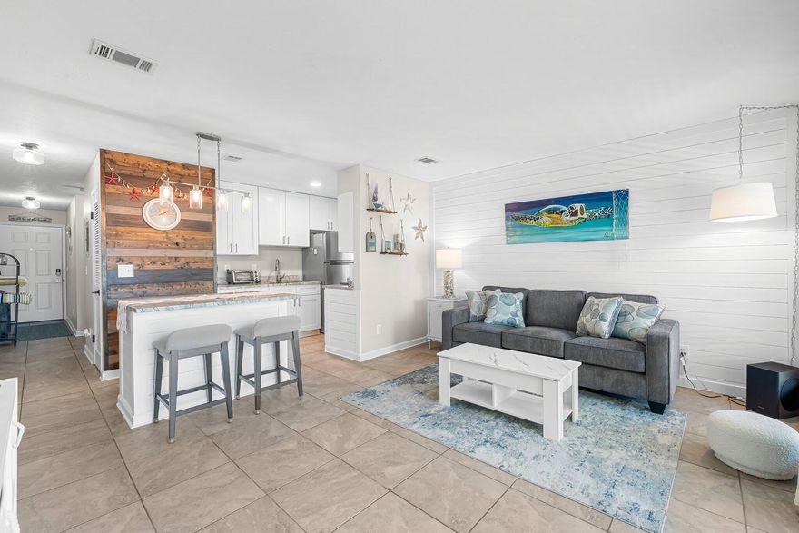 Beachfront Bliss at Nautical Watch - A Premier Coastal Retreat.Experience the ultimate in beachfront living with this stunningly updated vacation property at Nautical Watch. Nestled along the sugar-white sands of Panama City Beach, this exquisite one-bedroom, one-bath residence offers the perfect blend of comfort, style, and investment potential.Step inside to find a beautifully remodeled interior featuring elegant shiplap accents, sleek tile flooring throughout, and a thoughtfully designed open-concept living space. The chef-inspired kitchen boasts shaker-style cabinetry, quartz countertops, and a spacious island, ideal for hosting and entertaining. A custom bifold barn door discreetly conceals the full-size washer and dryer, adding both functionality and charm
Unwind in the spa-like bathroom, where modern tilework and high-end finishes create a serene retreat after a day on the shore. Open the brand-new sliding doors to your private balcony, overlooking the meticulously maintained resort-style pool- an idyllic setting for relaxation.

Whether you seek a tranquil beachfront escape or a lucrative short-term rental, this exceptional property delivers. Potential to sleep 5 comfortably. Contact the agent for rental income details and make this coastal gem yours today!