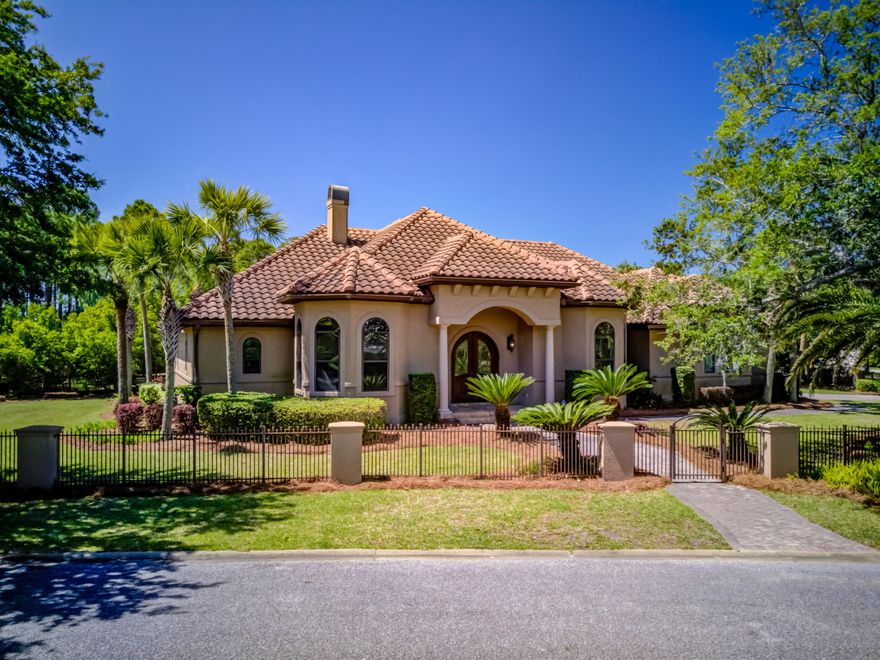 MAJOR PRICE IMPROVEMENT! Owner said price to sell!Mediterranean style home situated on the only fully gated corner lot in the upscale residential community of Regatta Bay Golf and Yacht Club. High-end finishes such as, beautiful hard wood floors throughout, custom cabinets, granite countertops and custom built-ins. The adjoining formal dining room is accented by an elegant chandelier. The cook's kitchen includes upgraded stainless appliances, beautiful pendant lights accent the center island, custom cabinetry and ample counter space. The well-appointed study sits just off the foyer with built in book shelves and large custom desk perfect for a home office workspace. Private Master Suite is show cased by warm recessed lighting and stunning gold leaf tray ceiling.