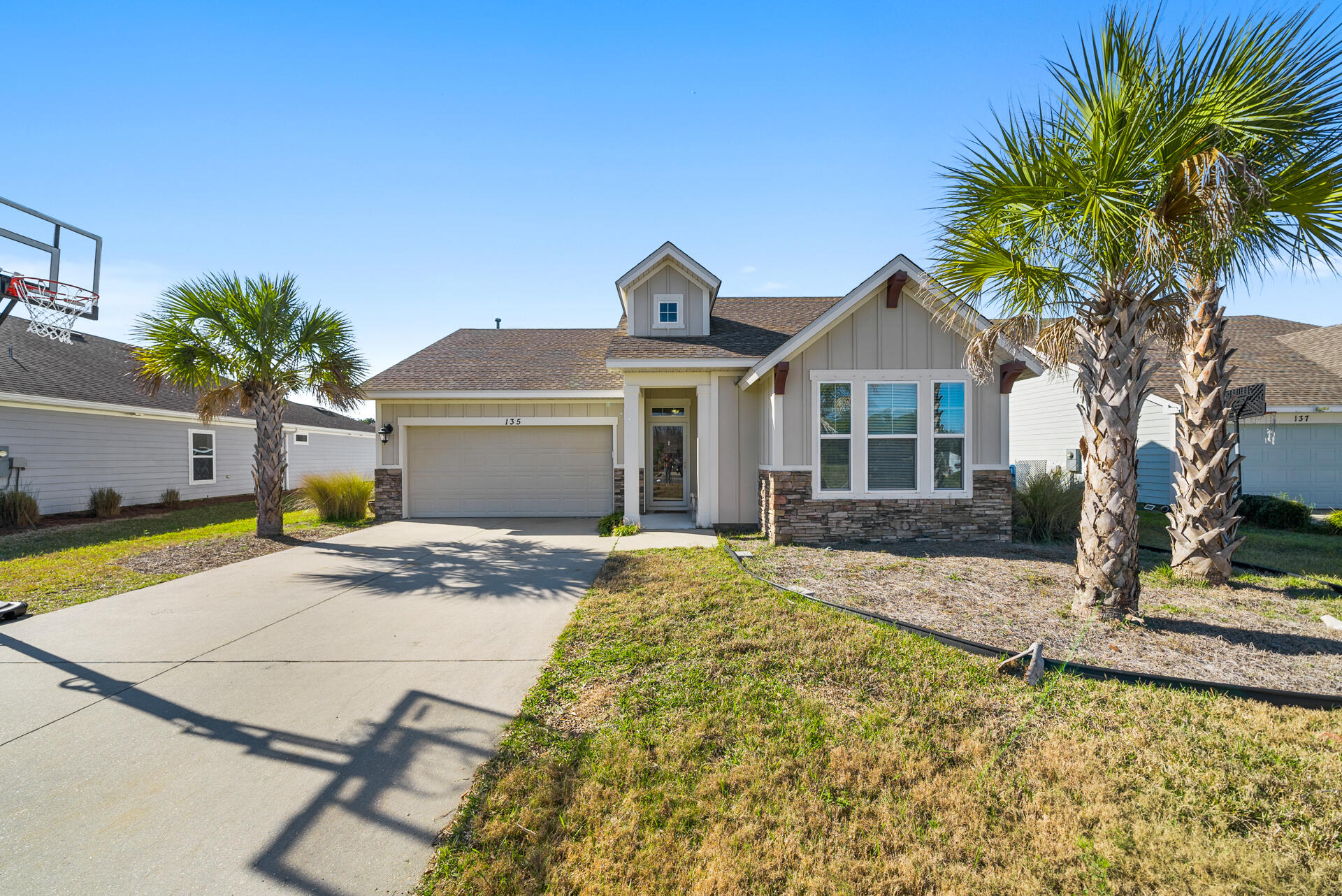 Located in the highly sought-after Breakfast Point community, this well-maintained home offers an open-concept design with modern finishes and high-quality construction throughout. The spacious layout is filled with natural light, creating a warm and inviting atmosphere. The gourmet kitchen features quartz countertops, stainless steel appliances, a large island, and custom cabinetry, making it perfect for cooking and entertaining. The master bedroom offers a walk-in closet, dual vanity, and a tiled walk-in shower for a private retreat. Enjoy outdoor living with an extended covered back porch overlooking a fully fenced backyard with mature landscaping for added privacy. Built with hurricane-rated construction, including 2x6 exterior framing and reinforced anchoring, this home offers durability and peace of mind. Situated in a quiet section of the neighborhood directly across from the park, this home is just minutes from shopping, dining, and the beautiful beaches of Panama City Beach. Don't miss this opportunity! Schedule your showing today!