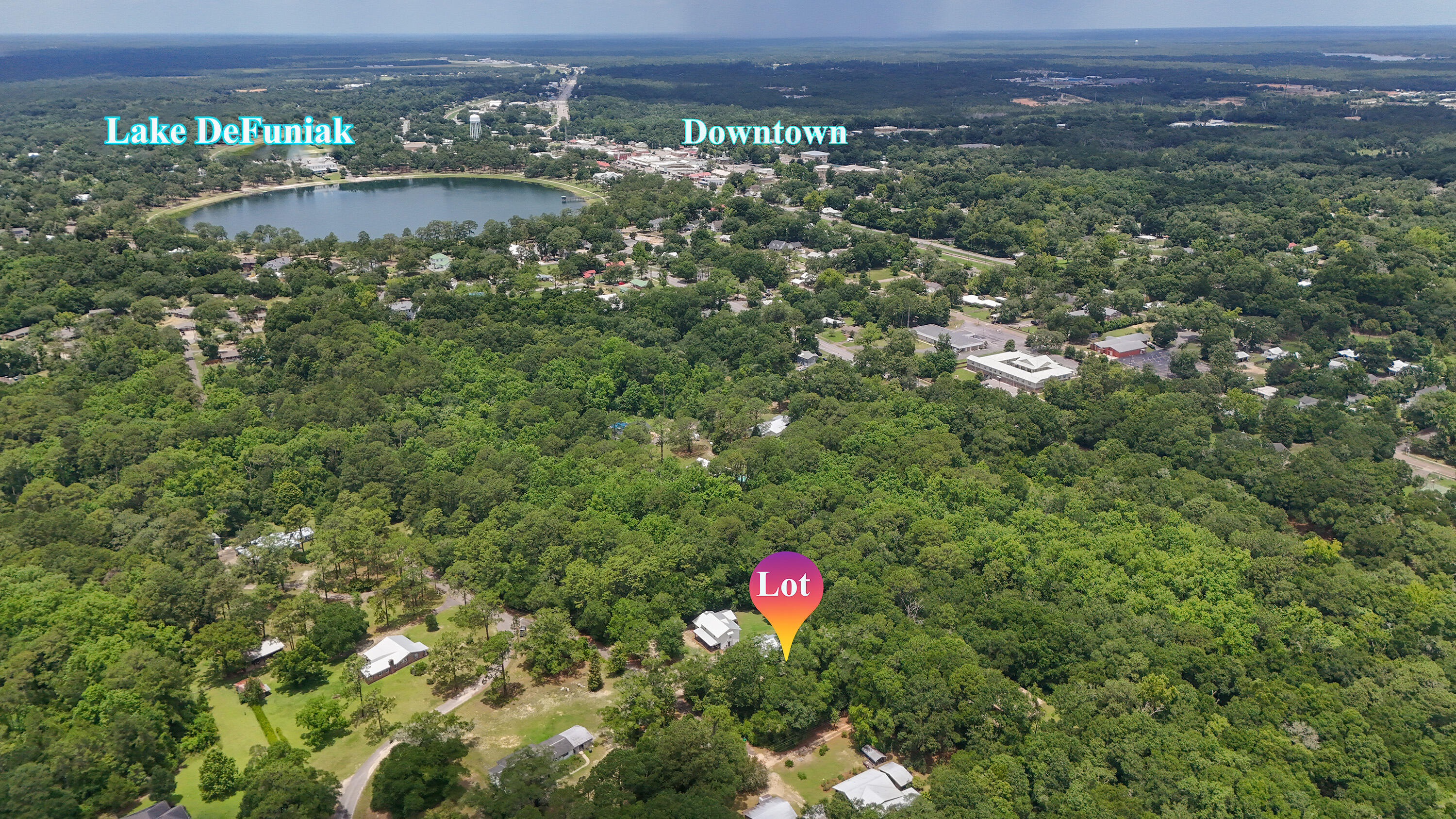 Rare, tucked away homesite in a well established neighborhood inside the city limits of DeFuniak Springs. Just a short walk or drive to Lake DeFuniak, and yet it feels completely hidden away in a serene setting. Wooded with availability of city water and city sewer and electric (taps unpaid). There is a 30' ingress/egress/utility easement over the easterly property line for the neighbors' access with about 50' in width for building.