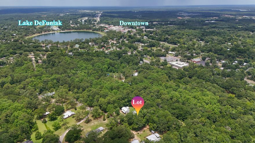 Rare, tucked away homesite in a well established neighborhood inside the city limits of DeFuniak Springs. Just a short walk or drive to Lake DeFuniak, and yet it feels completely hidden away in a serene setting. Wooded with availability of city water and city sewer and electric (taps unpaid). There is a 30' ingress/egress/utility easement over the easterly property line for the neighbors' access with about 50' in width for building.