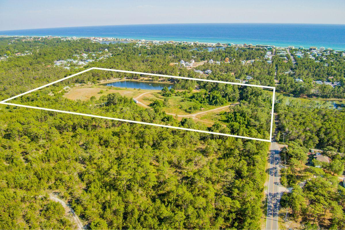 20 ACRES South of Hwy 98 with possible future access to the public beach! Located at the end of Sugar Drive just North of Stinky's Restaurant and Serenity at Dune Allen subdivision. Parcel is zoned small neighborhood with the possibility of 10 units per acre and 10 percent that can be commercial. This parcel is all natural, full of trees and has a .6 acre of a beautiful Cypress Pond that can not be touched, as well as a man made fish pond stocked with fish! Surrounded on 3 sides by State land, it is very secluded. Develop the property or use it as a huge private estate! Buyer is responsible for all due diligence and verifying lot dimensions.