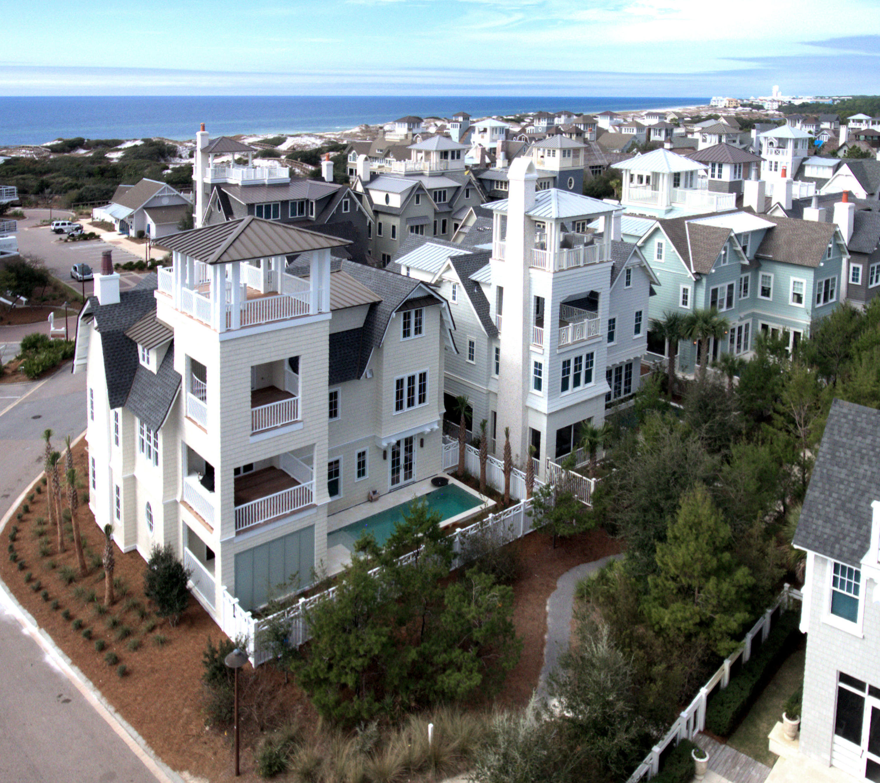 A Collaboration between the well-known Dune Construction and TS Adams Architecture is nearing completion and ready for you to make your own. The reverse open floor plan with large living-kitchen area uses its corner lot to capture views and breezes from the viewing corridor. The boardwalk leading through the dunes to the mile of beach frontage is 120 yards due south. The downstairs rec room leads to the spacious outdoor area with its inviting pool, screened sitting area, and outdoor fireplace. The third floor holds the master suite with a separate sitting area, wet bar, powder room, deck and covered porch which allows the owners to have guests to share the views or enjoy as their private retreat. Then the tower deck has forever panoramic views! 4,466 sqft with surprises everywhere.