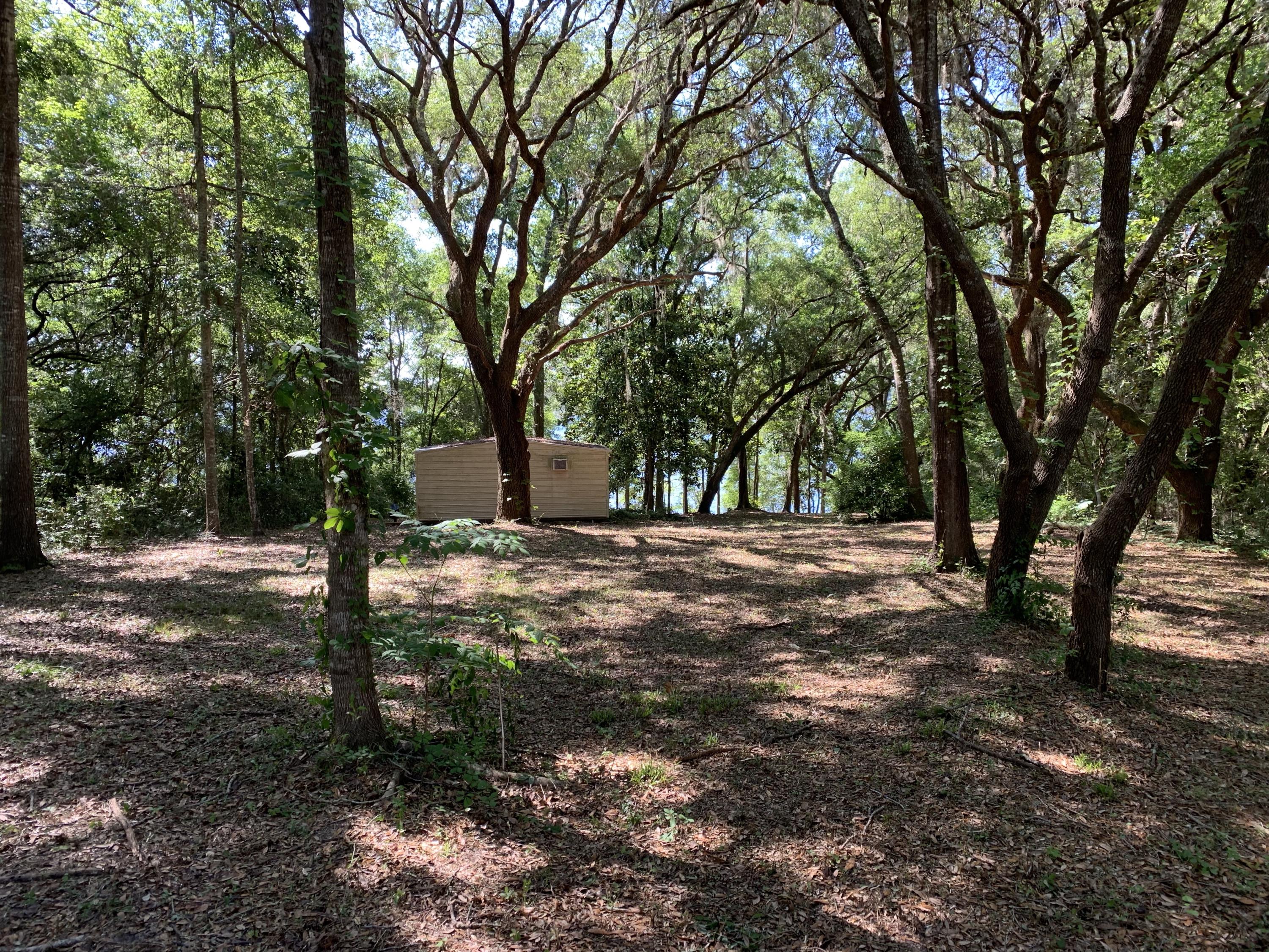 Beautiful half acre lot that's been cleared out backing up to Juniper Lake. This lot also is sold with an air conditioned 10x20 storage shed.
