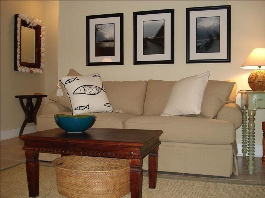 Located near the entrance of charming Cassine Garden in the second townhouse on the left, this unit is just a short walk to the sugar white sandy beaches. Whether you're looking for a vacation home, rental property or full time residence this townhouse fits them all! Updated and tastefully decorated in shades of white, cream, linen, and soft green accented with a touch of ocean blue set this unit apart. The functional floor plan offers living and kitchen area downstairs and two bedrooms upstairs with full bath. The kitchen features Silestone Quartz countertops & new appliances, spacious living and dining area, and half bath downstairs. The back sliding glass door leads out to a back patio, green lawn and tropical wooded landscaping. The two bedrooms upstairs each has its own balcony and