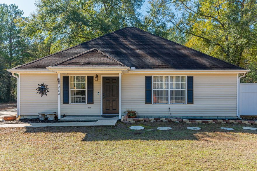 Oasis of secluded charm nestled on 1.16 acres, within minutes to shopping, schools, hospital and bases! Is 'land' and 'workshop' on your listing of must haves? This home is for you! This pretty gem has 3 bedrooms, 2 full baths, spacious laundry room & neat as a pin.  LVP and vinyl tile throughout. Not a fan of the custom vinyl? Not a problem, Seller has and is leaving the LVP to replace the black & white if that is not your style.  Large deck off the side to enjoy grilling, fire pit and sitting outside in the peaceful atmosphere. Notice the long extra wide drive to the detached garage/workshop...driveway has room for boat/RV or trailer with jet skis (whatever you want to park). Detached garage/workshop has electricity & TV hook-up, possibilities are varied for useThere is a fenced area for pets and/or children to keep them close by.  Notes to keep in mind: Roof will be replaced prior to closing, HVAC 2023, Septic pumped inspected 2025.  Concrete yard d??cor & pots do not convey.  See it to love it!